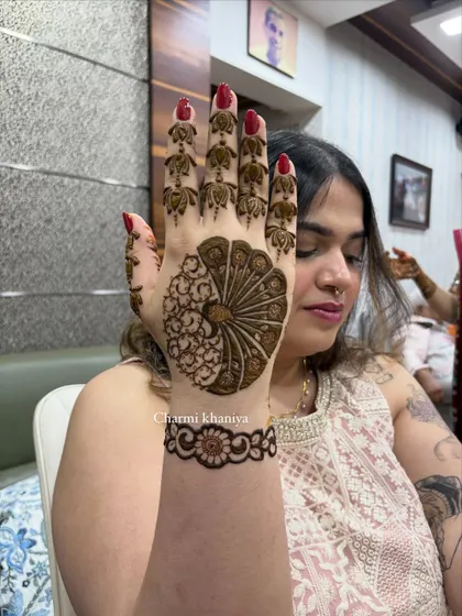 A close-up of the peacock design on one hand.