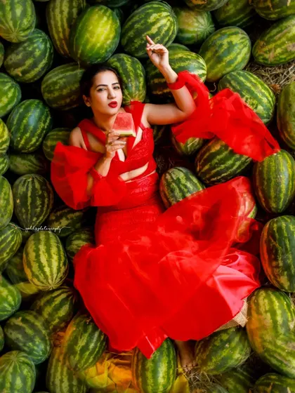 A creative and vibrant summer-themed shoot with an actress in a red outfit surrounded by watermelons. This series is playful and colorful, perfect for a brand campaign or a unique portfolio piece.