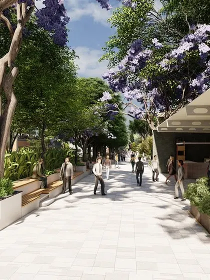 Another view of the shopping complex concept, highlighting a grand walkway flanked by classical sculptures, lush trees, and modern benches. This design aims to create an elevated, park-like shopping experience.