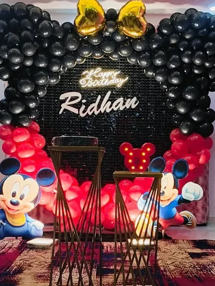 An identical shot of the Mickey Mouse setup, highlighting the neon "Happy Birthday" sign.