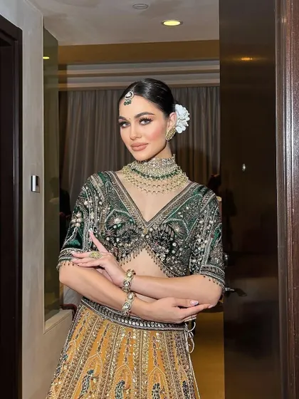 A modern bridal look in a unique combination of green and gold, perfect for a Mehendi or Sangeet.