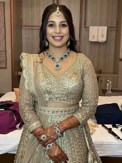A full view of the client looking radiant and happy. You'll learn to create these complete looks that make your clients feel confident and beautiful for their special events.