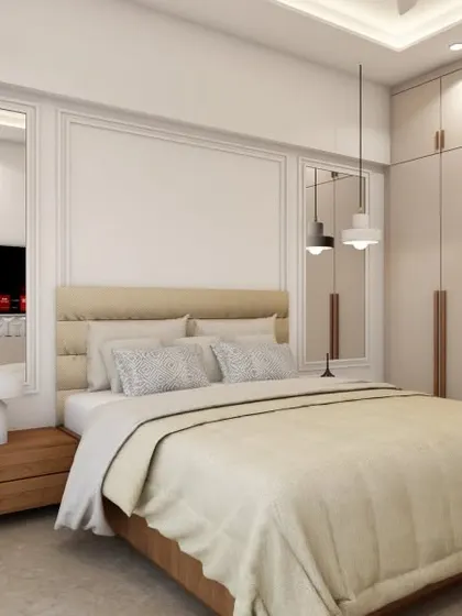 A bright and elegant bedroom with floor-to-ceiling wardrobes and mirrored panels beside the bed to create a sense of spaciousness. The pendant lights add a modern touch to the classic wall molding.