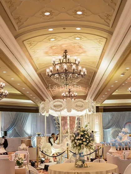 This wide-angle view showcases a grand carousel-themed birthday party we planned at the Taj Palace, New Delhi. The entire ballroom was transformed with luxurious draping, multiple crystal chandeliers, and a magnificent central carousel, demonstrating our ability to execute large-scale, luxury events.