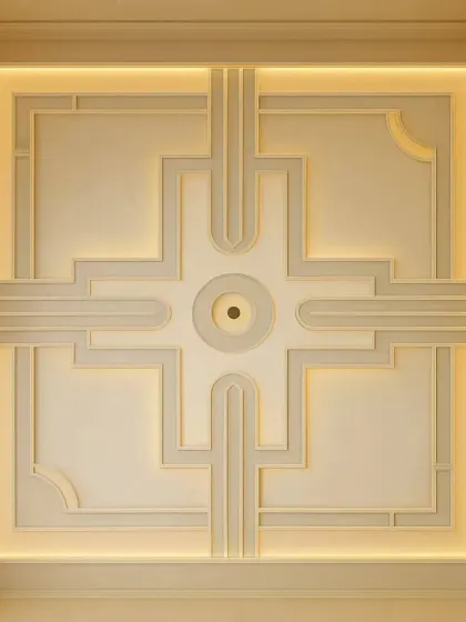 A perfect example of a modern, elegant false ceiling. This design uses clean geometric lines and warm, hidden cove lighting to give the room a sophisticated feel without being overpowering.