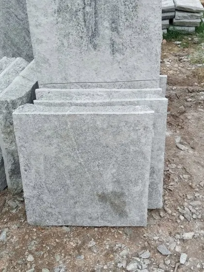 A close-up of a square Narasapura stone paver, highlighting its natural, earthy texture.