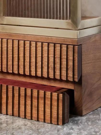 Details are the language of quality. Here, you see the precise fluting on a solid wood drawer, which opens to reveal a rich, red velvet lining. It is these hidden moments of craftsmanship that define our approach to bespoke furniture design.