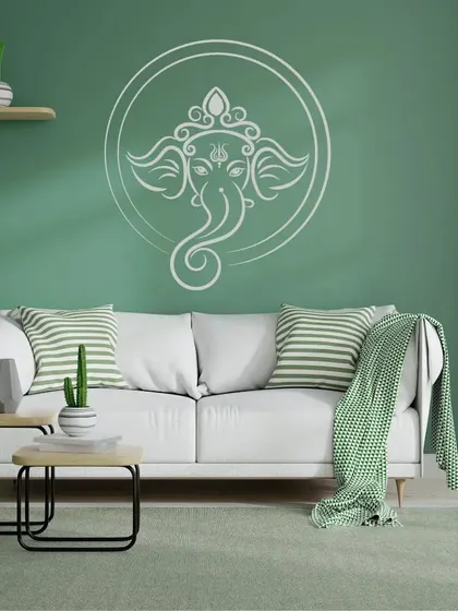 A serene Ganesha design within a circle, painted on a calming green wall. This artwork brings a sense of peace and auspiciousness to the home.