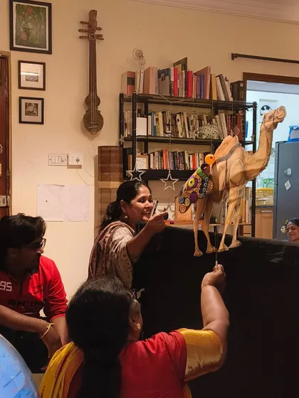 A puppet show in full swing during a children's party. These shows are a wonderful way to tell stories, teach lessons, and spark laughter. Here, a camel puppet captivates the young audience.