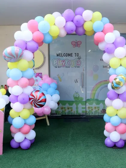 The party starts the moment you arrive! We love creating a grand entrance, like this sweet Candyland theme, complete with a colorful balloon arch and giant popcorn boxes to welcome your guests to a world of fun.