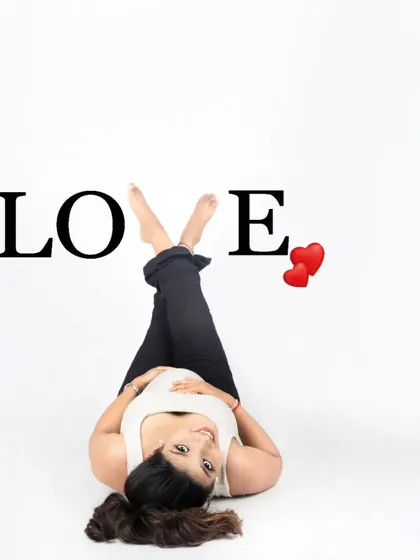A fun and modern take on a maternity photo. This playful pose with the word 'LOVE' is a great way to express your happiness in a creative and casual style.