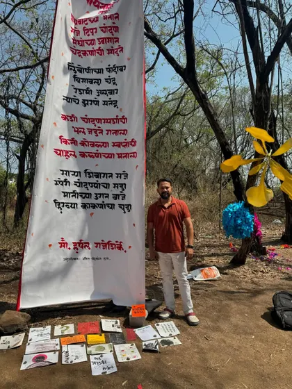 Standing with the completed calligraphy banner at the Gulmohar Day event. It was a wonderful celebration of nature and art.