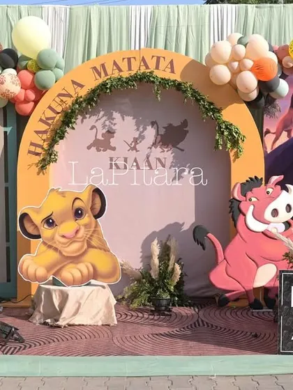 A 'Hakuna Matata' photo booth for the Lion King party, featuring young Simba and Pumbaa. It's a fun and carefree spot for guests to take pictures.