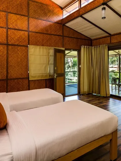 The spacious bedroom of the jacuzzi suite, with large glass doors that lead out to your private balcony.