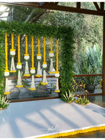 A close-up of the fern frame and floral streamers, highlighting the craftsmanship and natural beauty of the design.