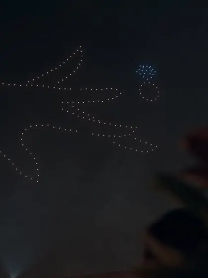 The moment of "yes," recreated on a celestial scale. This drone formation of a hand placing a ring on a finger is a powerful and creative way to celebrate an engagement or proposal.