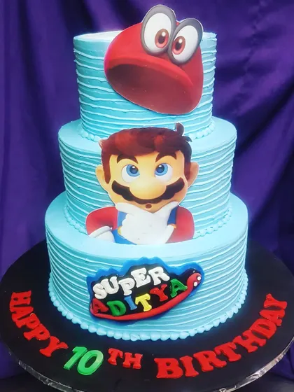 This three-tier Super Mario cake is ready for an adventure. Featuring Mario and his iconic red hat, it's a fun and vibrant cake for a 10th birthday party.