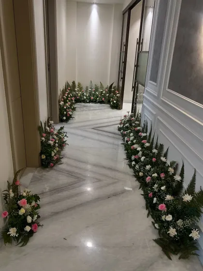 A beautiful floral runner decorating the hallway for a home wedding function. This simple touch adds elegance and a celebratory feel to the space.