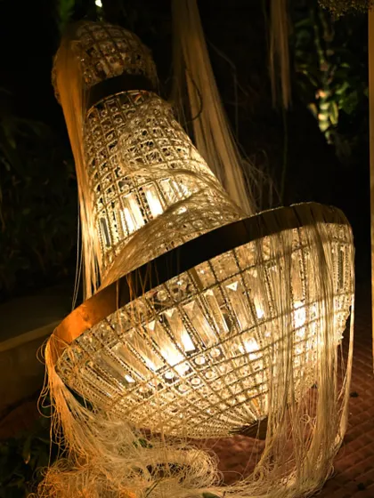 A unique, deconstructed chandelier placed on the ground as a decorative piece. This artistic touch adds an element of surprise and creativity to the decor.