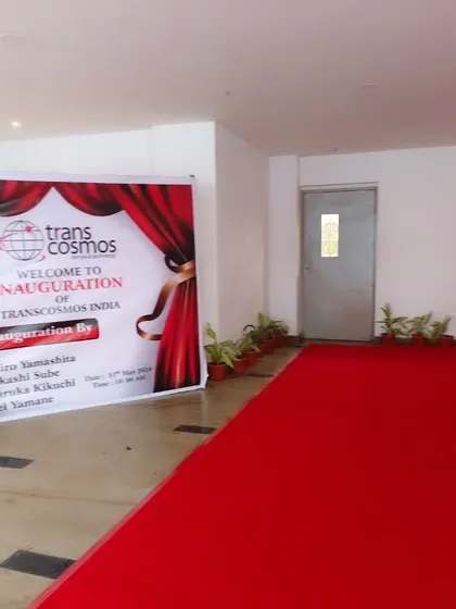 A simple and effective welcome setup for the Trans cosmos inauguration, featuring a branded banner and a red carpet to clearly mark the entrance for guests and dignitaries.