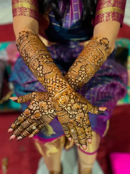 A lovely pose showcasing the traditional bridal henna against the bride's beautiful silk saree.