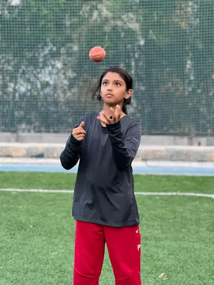 A young girl from our academy practices her ball-handling skills, showcasing the focus and determination we nurture in all our players.