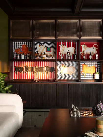 A direct look at the custom bar cabinet, which I designed to be both a functional storage unit and a piece of art. The playful cow motifs add a touch of personality and humor to the elegant space.