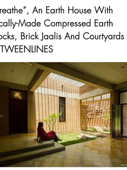 A publication feature on the "Breathe" residence, highlighting its use of locally-made compressed earth blocks, brick jaalis, and courtyards to create a sustainable and contextually relevant home.