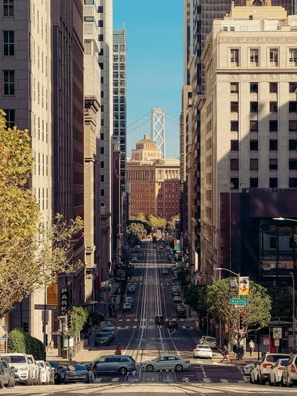 Looking down California Street in San Francisco towards the Bay Bridge. This classic city view uses leading lines and compression to create a powerful sense of depth and scale.