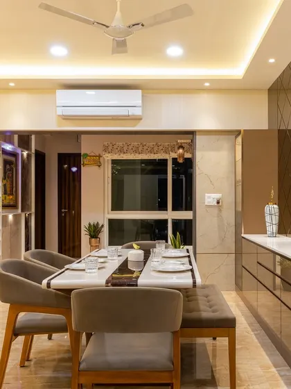 A wide shot of the living and dining area, showing the seamless flow between the spaces, unified by a luxurious marble floor and a consistent color palette.