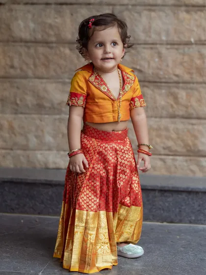 Another shot of our little client, her collared blouse and brocade skirt making for a unique and stylish traditional outfit.
