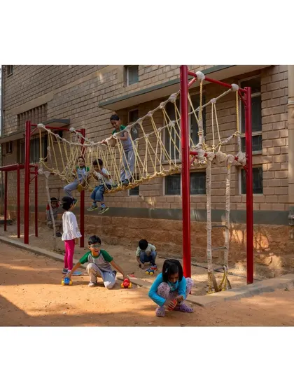 A rope bridge and play structure at Buddhi School, integrated directly with the building. We believe that play is essential to learning, and our designs create numerous opportunities for physical activity.
