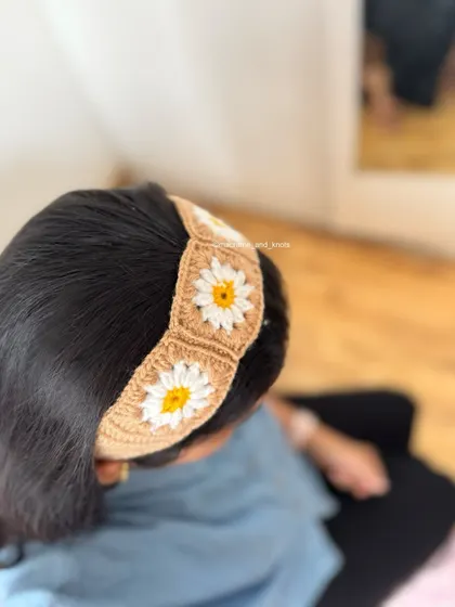 Here is another view of the crochet daisy headband being worn. It sits comfortably on the head and adds a really sweet, handmade touch.