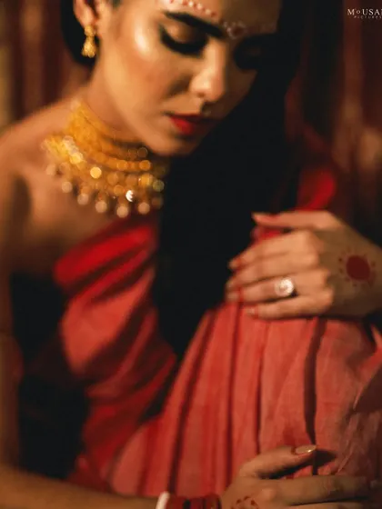 A soft-focus, artistic shot that creates a sense of intimacy and mystery. The blur and warm tones give this editorial portrait a painterly quality.