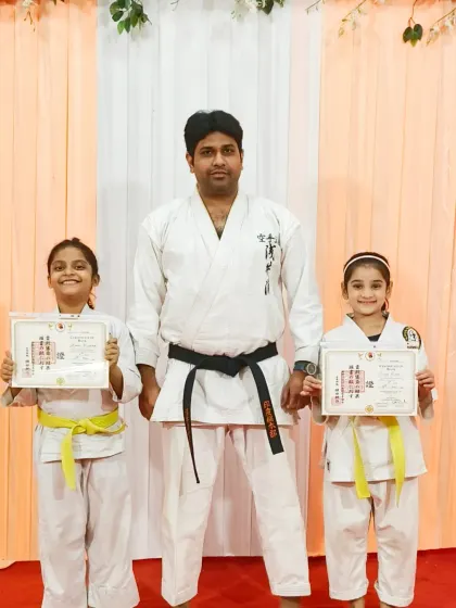 Two of my youngest female students proudly holding their yellow belt certificates. It is especially important to me that girls feel empowered and confident through martial arts training.