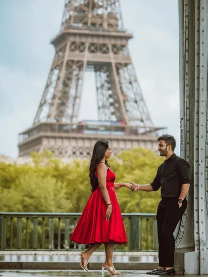 A romantic shot of the couple with the Eiffel Tower in the background.