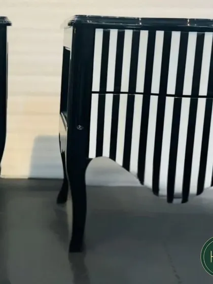 Another angle of the black and white striped cabinets, emphasizing their unique curved shape and dramatic visual appeal.
