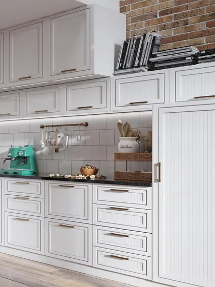 This image showcases extensive storage in a classic white kitchen. The design features numerous drawers and cabinets with profiled shutters and slim brass handles, combining traditional aesthetics with modern storage needs.