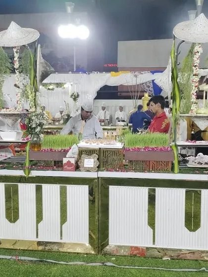 A farm-themed salad buffet counter with wheatgrass planters and traditional Indian farmer hats, showcasing my creative approach to event catering.