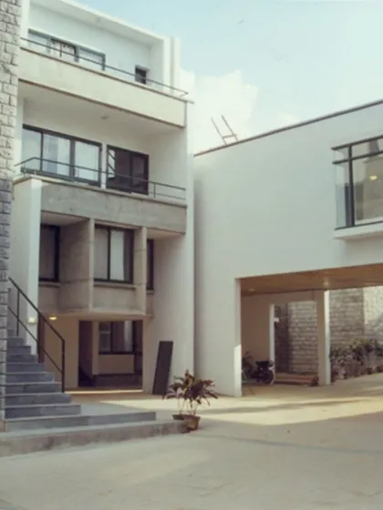 The housing for married students at IIM-B, designed in 2002. This project explored a split-level, staggered arrangement to create dynamic spaces and provide each unit with either a private garden or a terrace.
