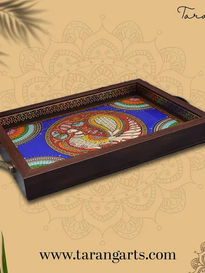 This exquisite tray features a glass painting of the divine Annapakshi. The vibrant colors and traditional design make it a beautiful piece for serving or as a decorative accent in your home.