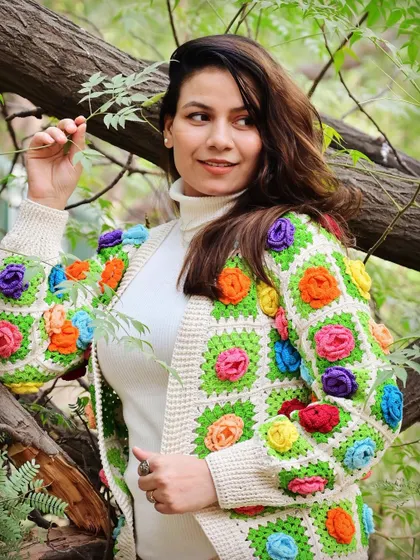 Our granny square jacket, adorned with colorful 3D flowers, is a celebration of vibrant, wearable art. It’s a modern take on a classic crochet technique, perfect for those who love to wear their personality.
