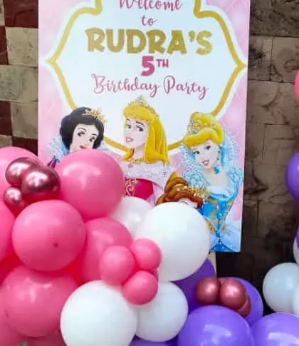 A close-up of the welcome sign for a princess themed party, featuring classic Disney princesses. This custom sign adds a personal touch to the event entrance.