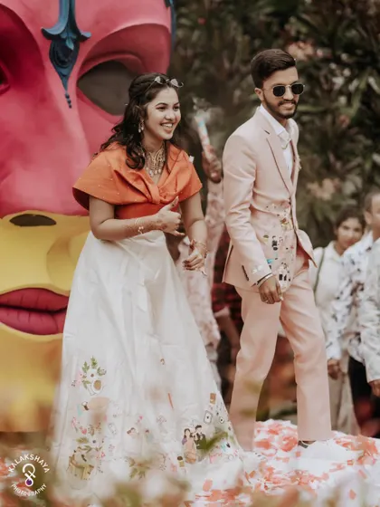 The couple dancing and enjoying themselves on stage at their colorful carnival party.