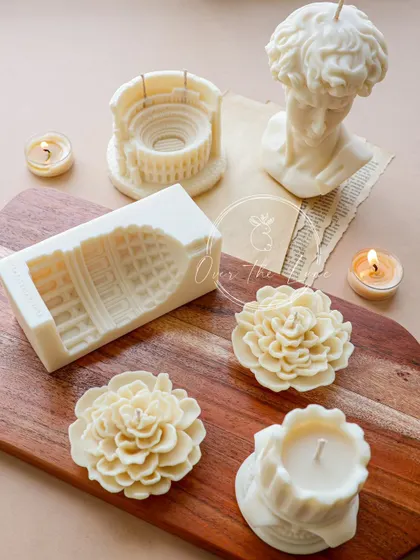 "Every block of stone has a statue inside it..." Here are some of my uncolored wax sculptures, showing the pure form of the Colosseum, David, and Camellia candles before I add color.