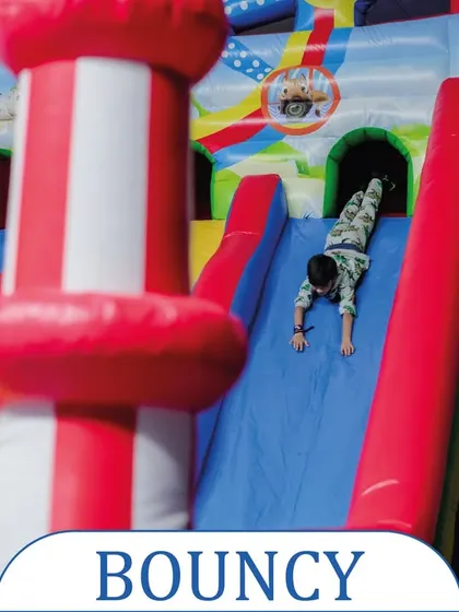 A classic bouncy castle with a slide is always a crowd-pleaser. This colorful inflatable provides hours of jumping and sliding fun for children.