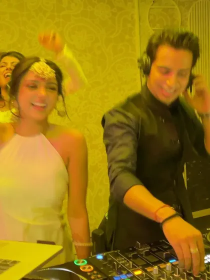 A candid shot of the bride dancing next to me, lost in the music. The yellow lighting and her happy expression perfectly capture the after-party vibe.