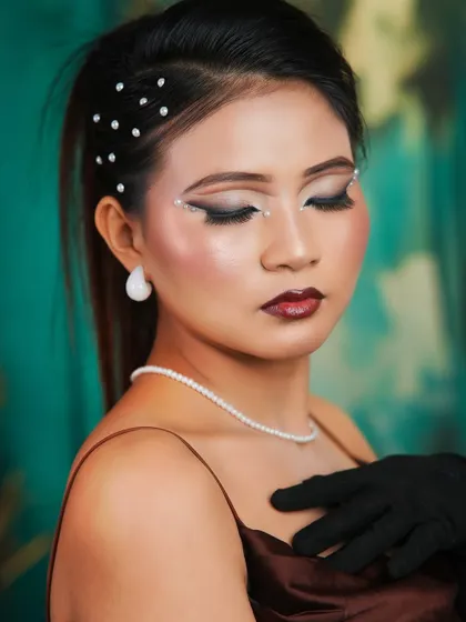 A close-up on the eye makeup, showing the delicate pearl accents and the perfectly blended eyeshadow.