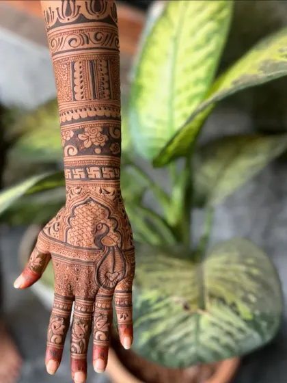 A close-up of the peacock motif on the palm from the previous image.