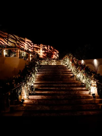 The grand staircase illuminated at night, creating a dramatic and inviting entrance.